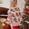 Festive embroidered Christmas sweater paired with a red mini skirt, capturing a cozy holiday atmosphere with decorations and gifts.