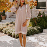 A cozy knit mini dress in warm taupe, perfect for fall outfits and layering.