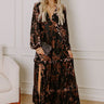 Elegant black velvet burnout maxi dress with floral details, styled for a sophisticated winter evening.
