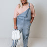 The Caspin Distressed Overalls In Light Wash Curves Image - 1
